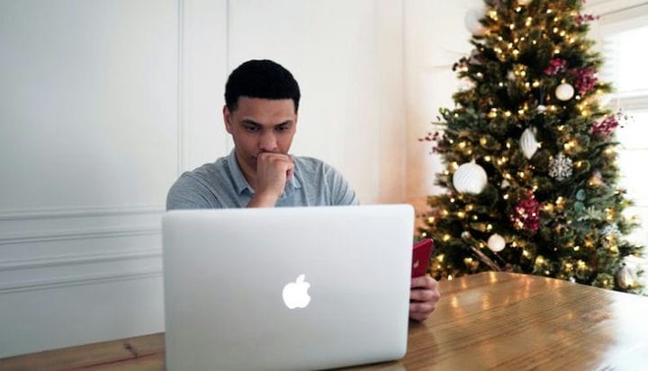 man in gray crew neck shirt sitting in front of silver macbook