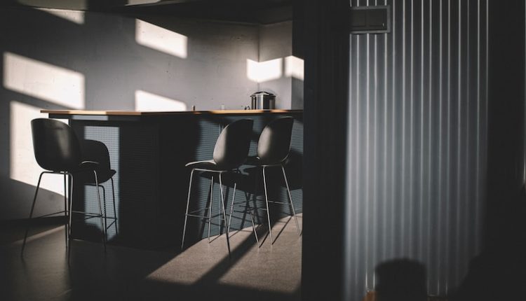 black metal chair near white window blinds
