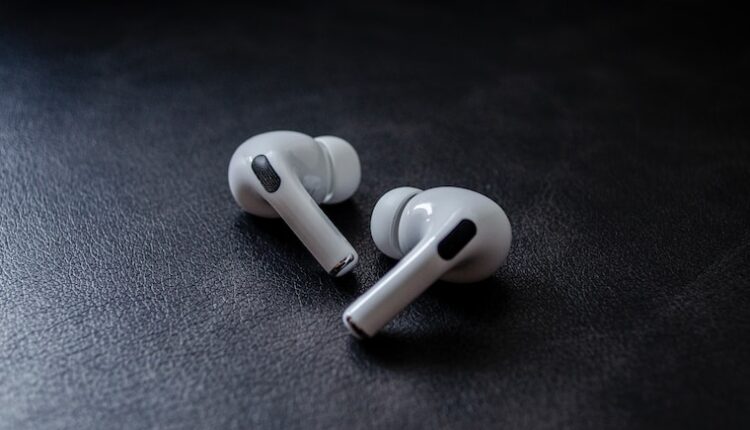 white earbuds on black textile
